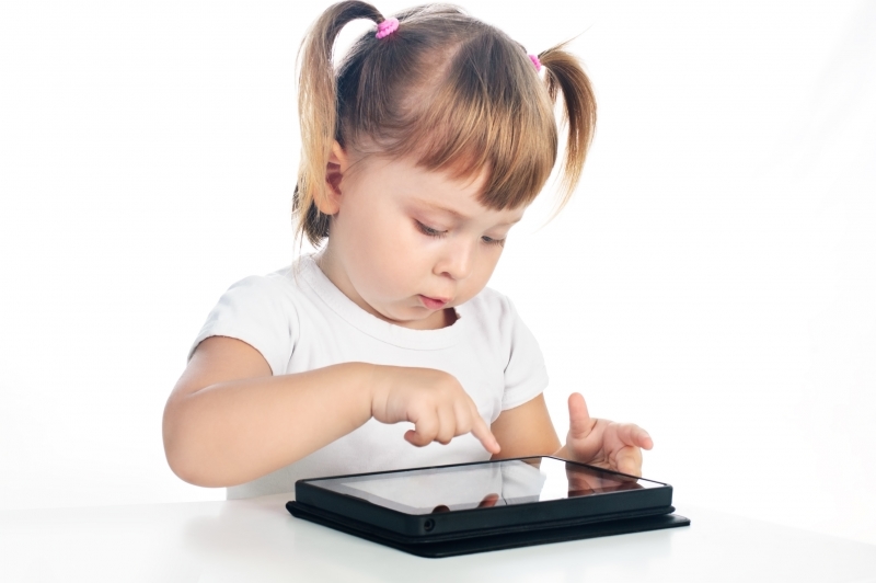 3828700-serious-3-years-old-girl-with-tablet-isolated-over-white